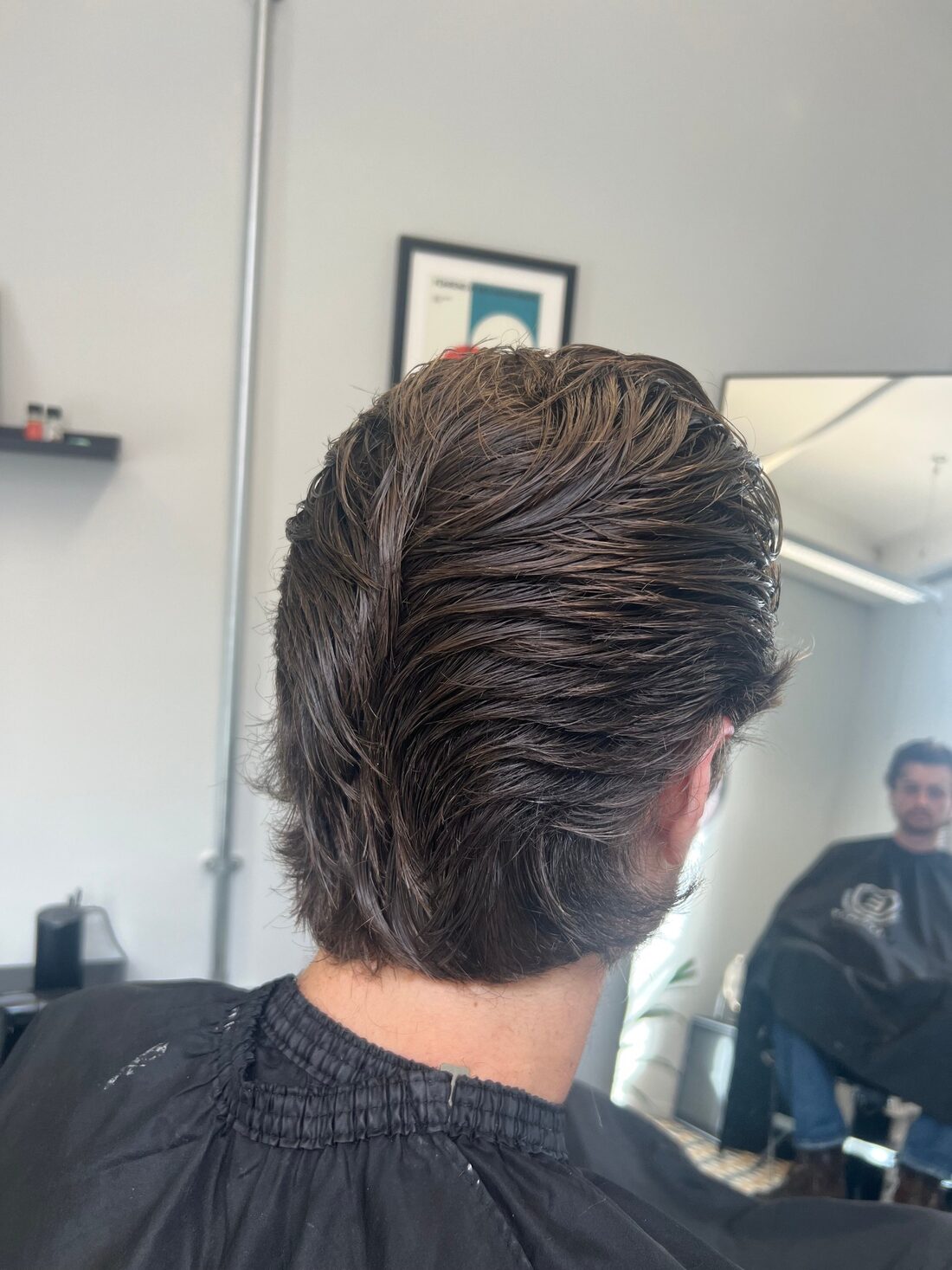 Slicked-back longer cut from behind